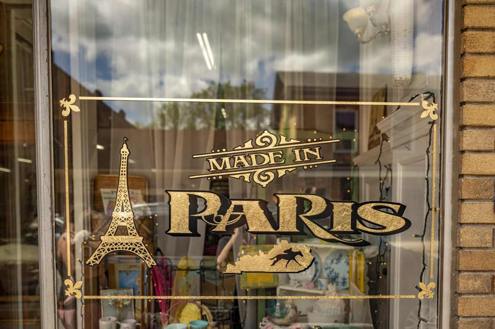 "Made in Paris" lettering and an Eiffel Tower painted on a shop window