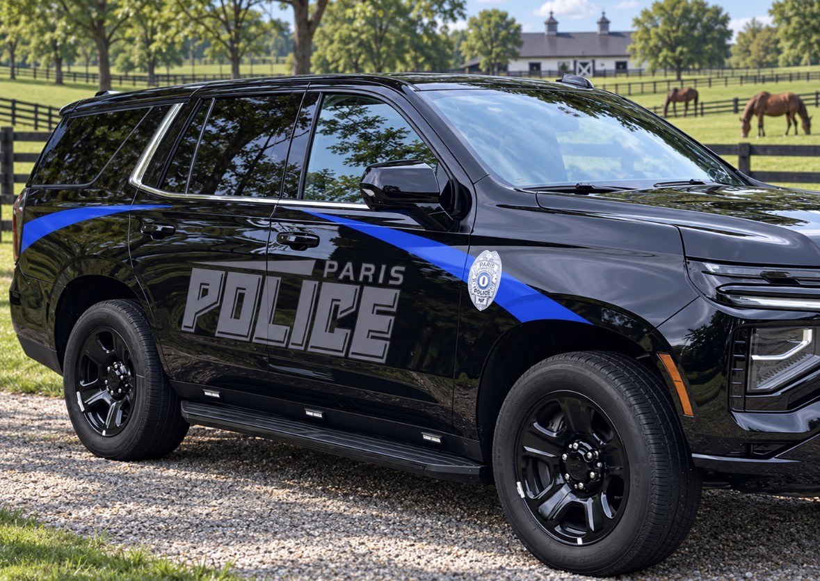 Paris Police Department patrol SUV, black with a blue stripe and the Paris Police badge on the door.